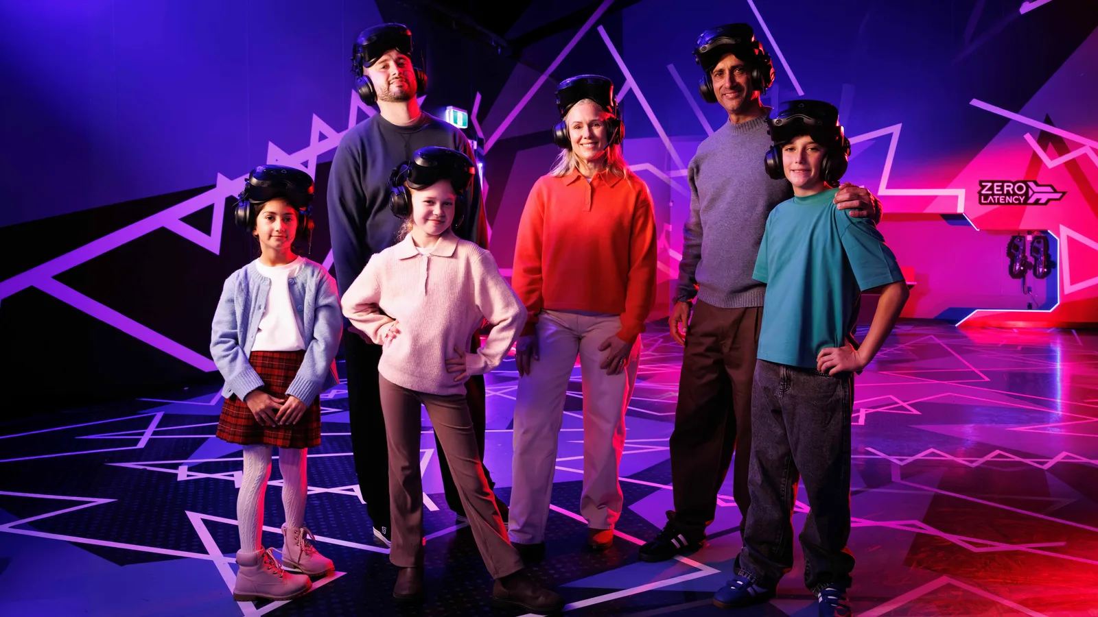 Family with kids wearing VR headsets in the Zero Latency arena